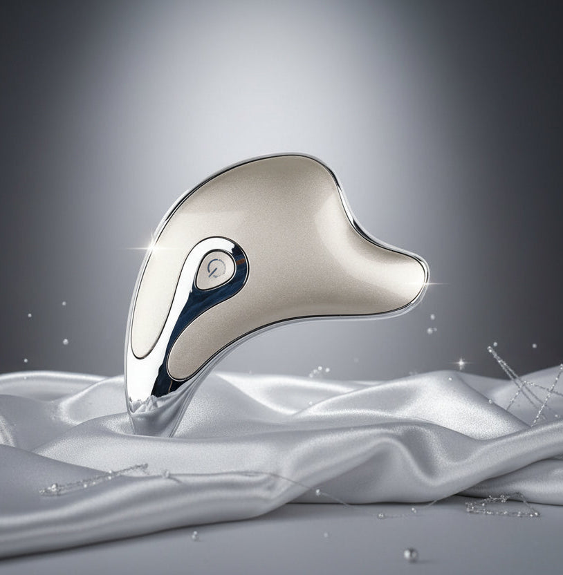 Ergonomic silver handheld electric massager with power button on white background