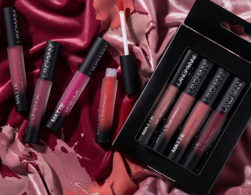 Matte lipstick tubes in various shades including red and pink branded LANGMANNI on white surface with black sparkly background