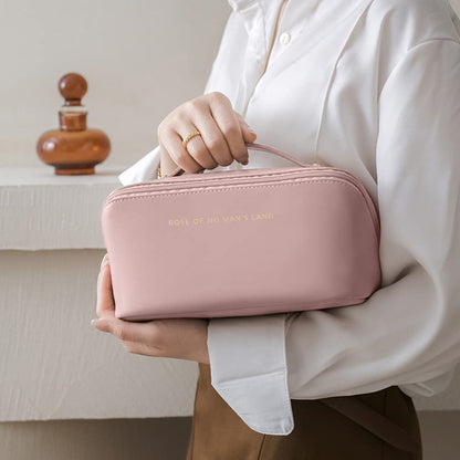 Person holding a pink travel bag with branding.