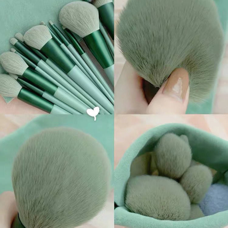 Set of soft green makeup brushes with different shapes and sizes on matching fabric background
