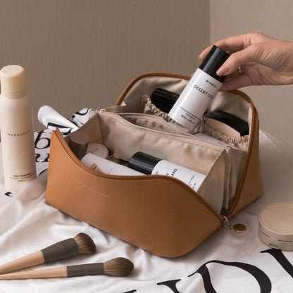 Cosmetic bag with skincare products and makeup brushes on a light background