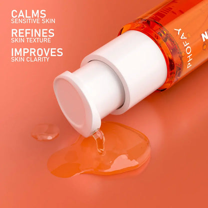 Orange skincare product with droplets on an orange background, featuring the brand 'Phofay'.